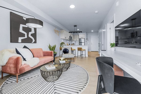 Spacious living room with contemporary design and plush seating at Ion Town Center Apartments