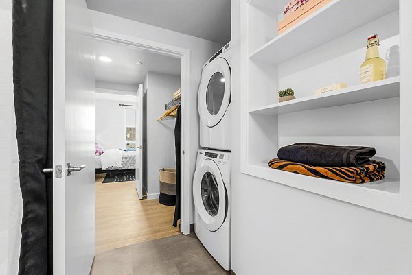Laundry room with energy-efficient machines at Ion Town Center Apartments