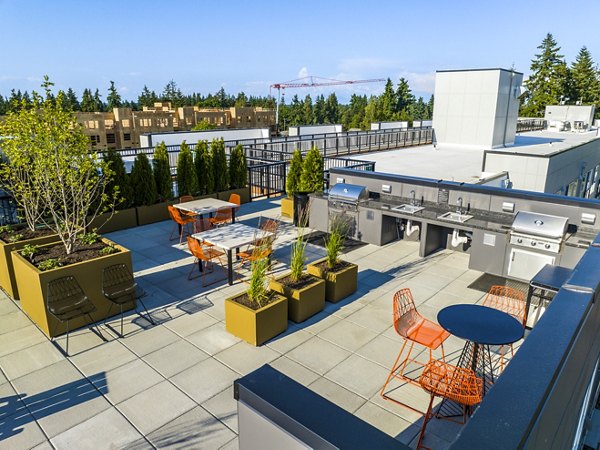 Cozy outdoor grill area and patio at Ion Town Center Apartments, perfect for hosting gatherings in a stylish community setting