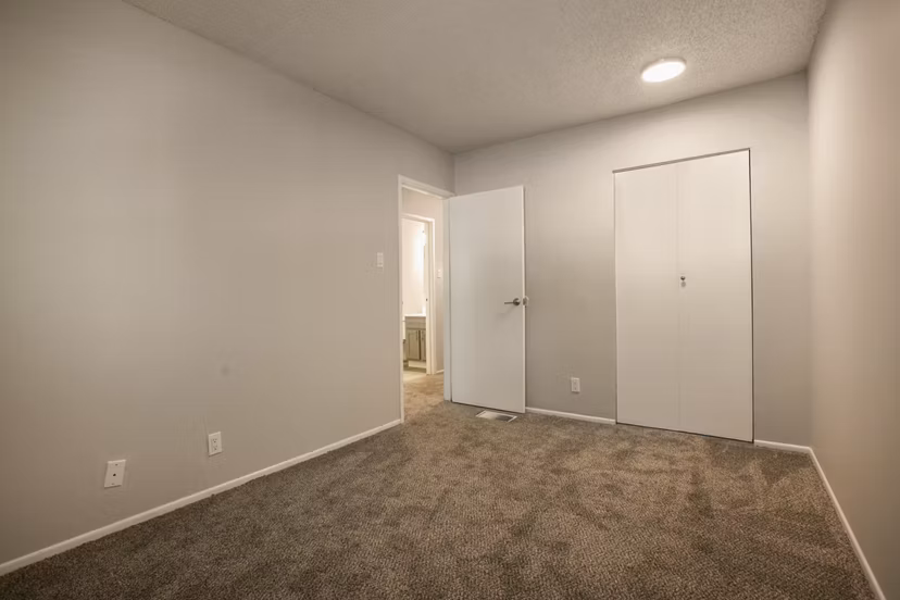 Bedroom featuring elegant decor and modern furnishings at Sun Plaza Apartments