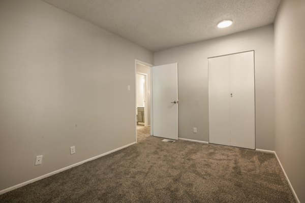 Bedroom featuring elegant decor and modern furnishings at Sun Plaza Apartments
