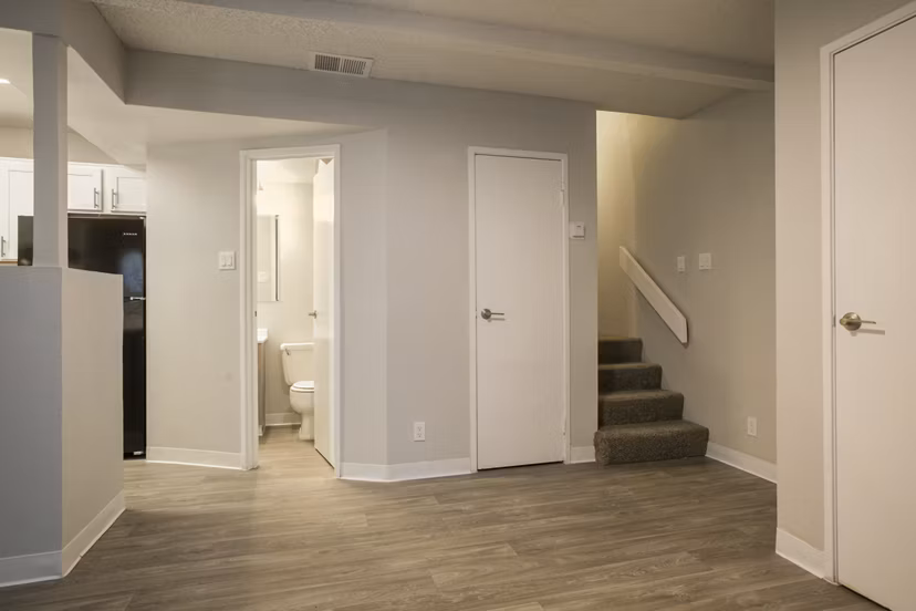 Bright hallway with modern decor at Sun Plaza Apartments, featuring contemporary lighting elements