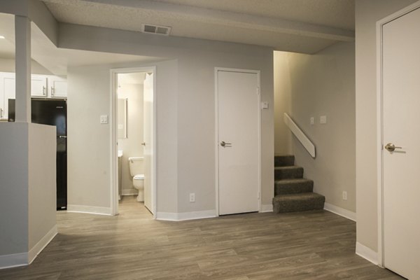 Bright hallway with modern decor at Sun Plaza Apartments, featuring contemporary lighting elements
