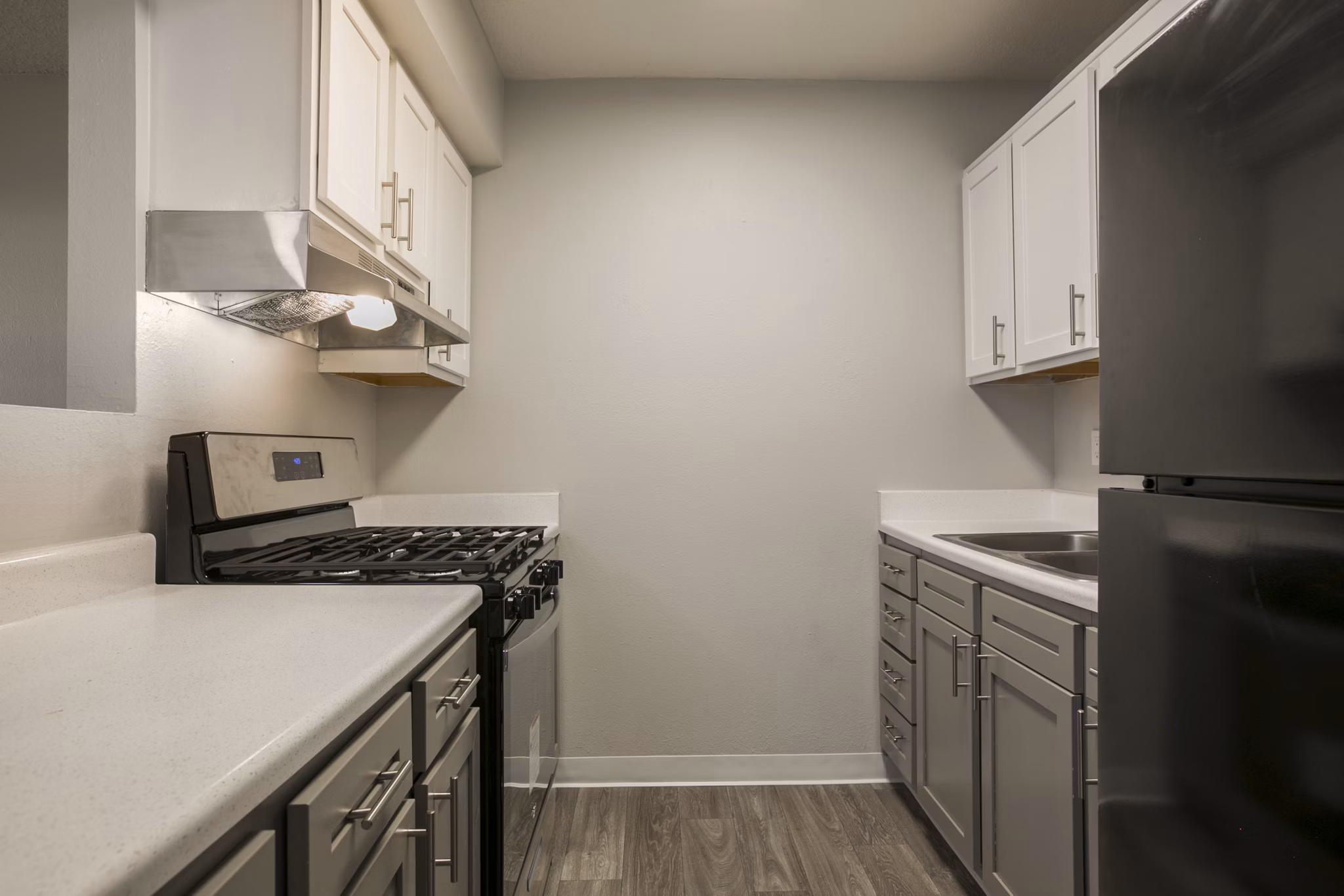 Modern kitchen with stainless steel appliances in Sun Plaza Apartments, a luxury Greystar property