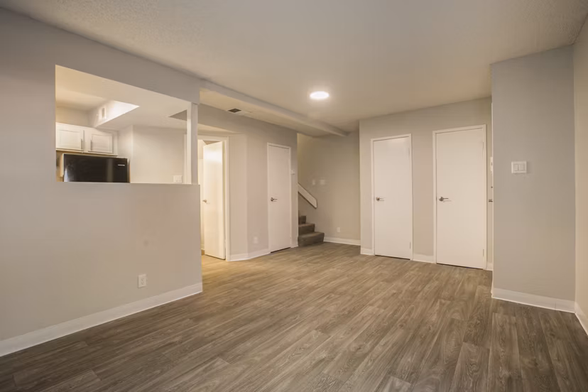Elegant living room with modern decor and large windows at Sun Plaza Apartments, offering a luxurious lifestyle in a Greystar-managed property