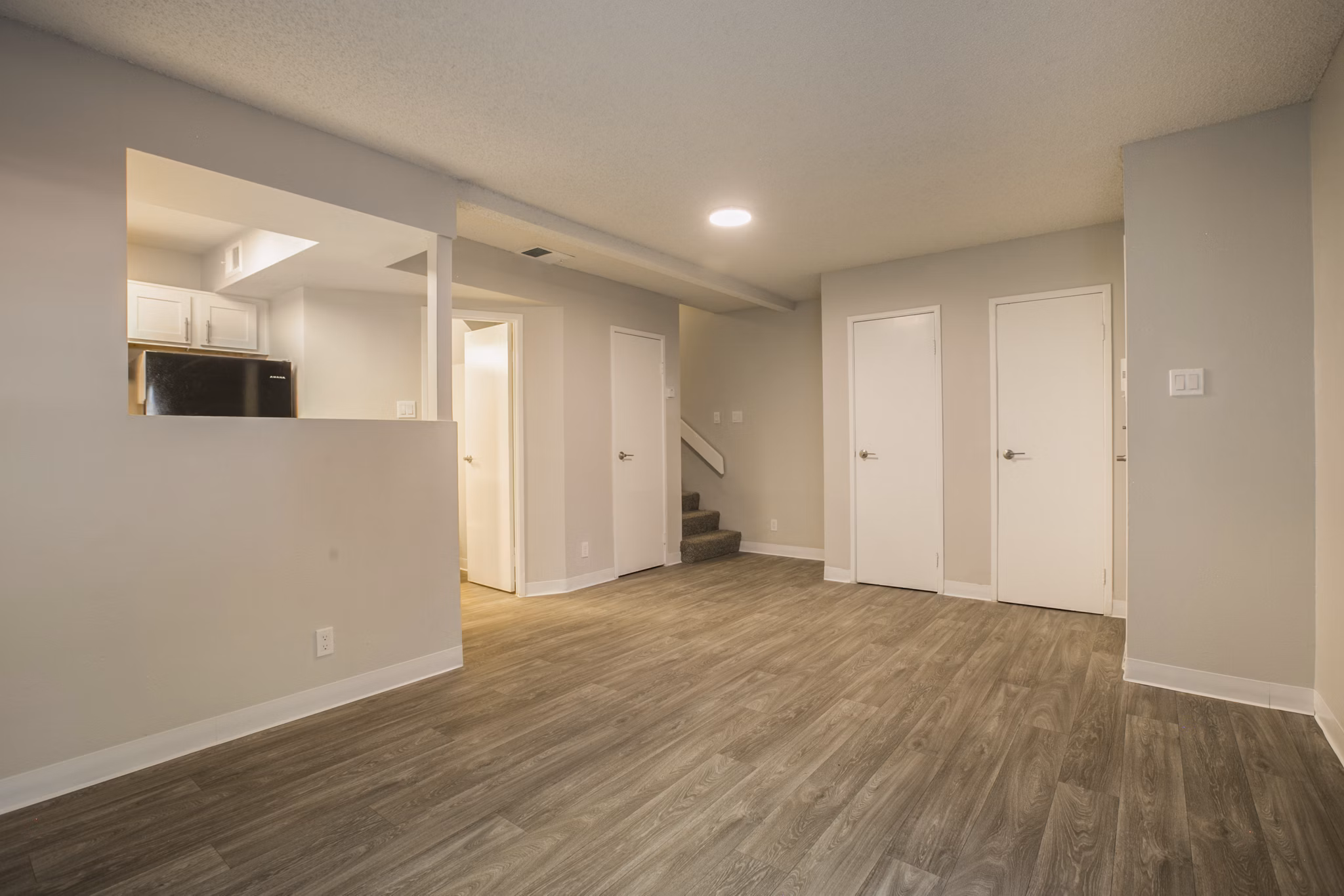 Elegant living room with modern decor and large windows at Sun Plaza Apartments, offering a luxurious lifestyle in a Greystar-managed property