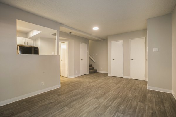 Elegant living room with modern decor and large windows at Sun Plaza Apartments, offering a luxurious lifestyle in a Greystar-managed property