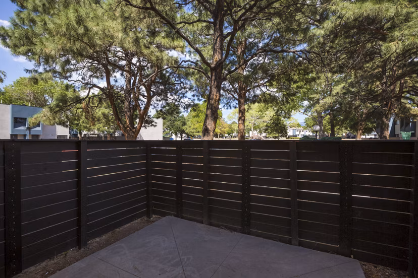 Sun Plaza Apartments: Spacious patio with modern lounge furniture, ideal for relaxation and entertaining in a luxury setting
