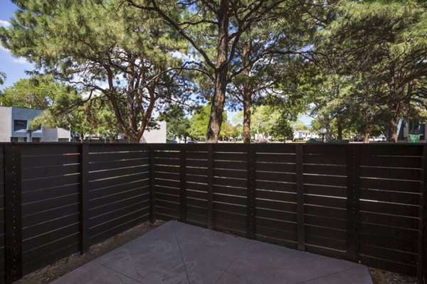 Sun Plaza Apartments: Spacious patio with modern lounge furniture, ideal for relaxation and entertaining in a luxury setting
