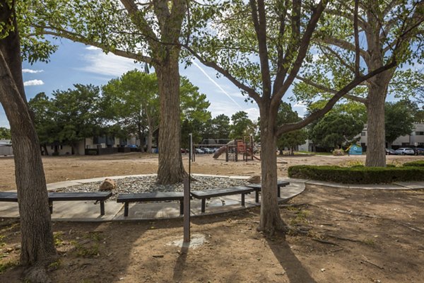 Courtyard with lush landscaping and seating at Sun Plaza Apartments