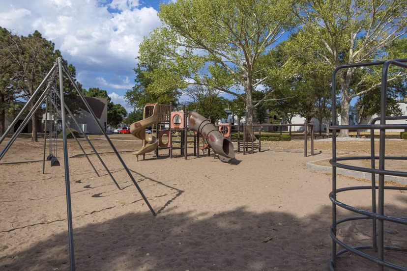 Playground at Sun Plaza Apartments: Modern play area with swings and slides in the Sun Plaza Apartments community