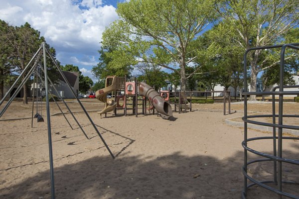 Playground at Sun Plaza Apartments: Modern play area with swings and slides in the Sun Plaza Apartments community