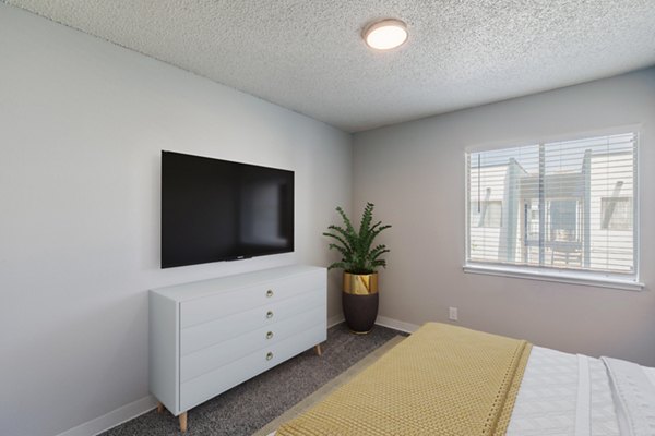 Comfortable bedroom with modern decor at Valley Apartments, offering luxury living in a serene environment