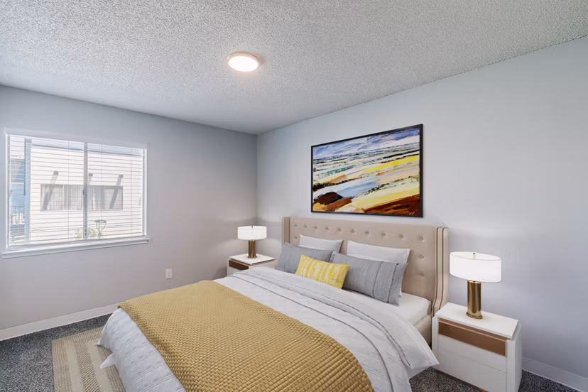 Cozy bedroom with modern decor and ample natural light at Valley Apartments