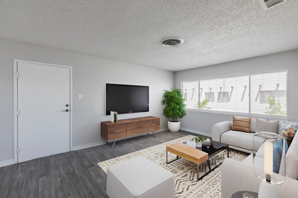 Living room with modern decor and natural light at Valley Apartments by Greystar