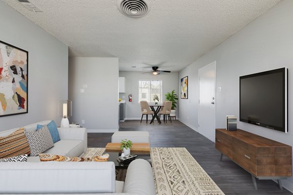 Spacious living room with modern decor and large windows in Valley Apartments