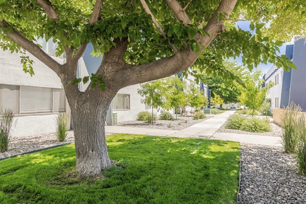 Valley Apartments: Serene courtyard with lush landscaping and outdoor seating for relaxation and socializing