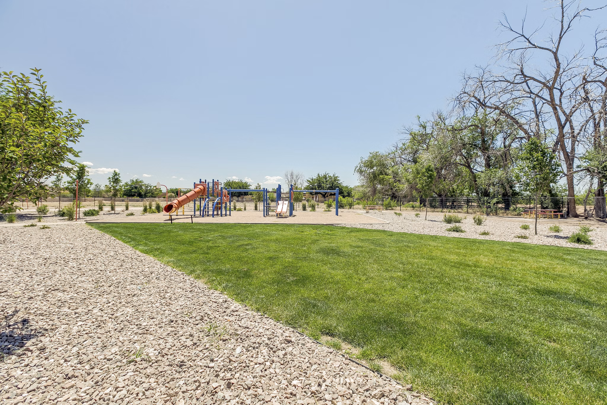 Spacious playground with colorful equipment at Valley Apartments, perfect for families and residents seeking active outdoor fun