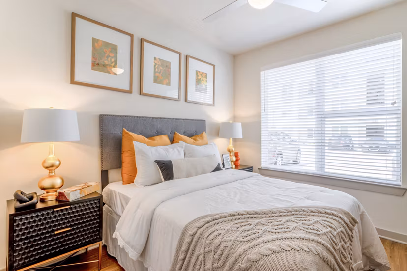 Cozy bedroom with modern design and ample natural light at Espria Apartments, luxury living in the heart of the city