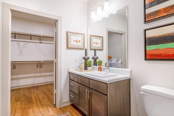 Modern bathroom with sleek fixtures and spacious vanity in Espria Apartments