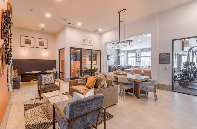 Modern clubhouse with cozy seating and billiards table at Espria Apartments