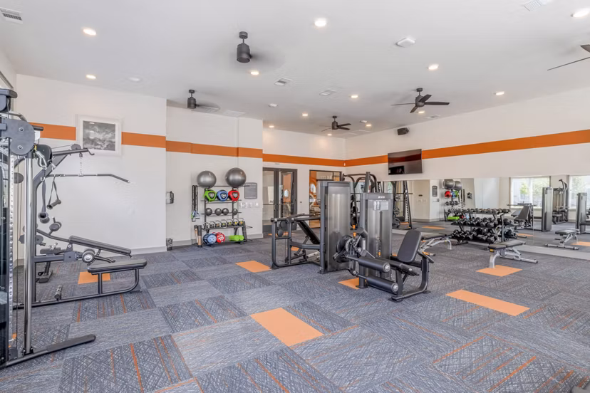 State-of-the-art fitness center with weights and cardio equipment at Espria Apartments
