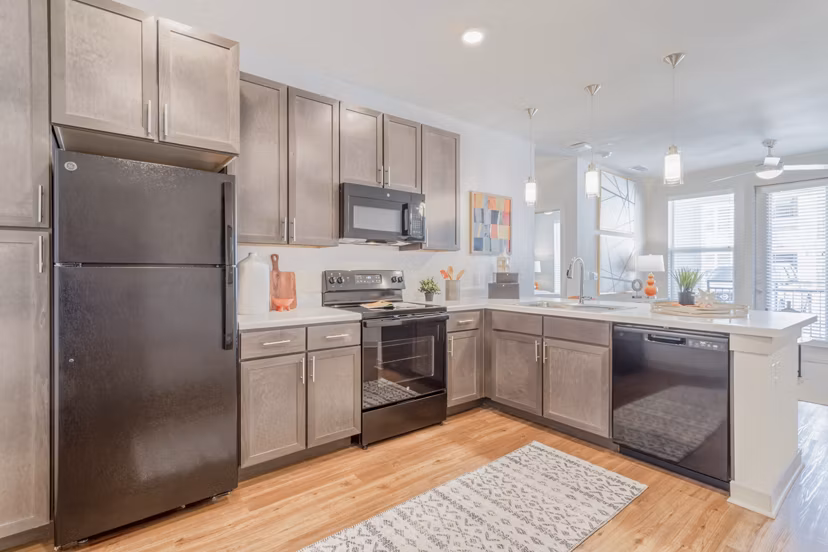 Modern kitchen with stainless steel appliances in Espria Apartments