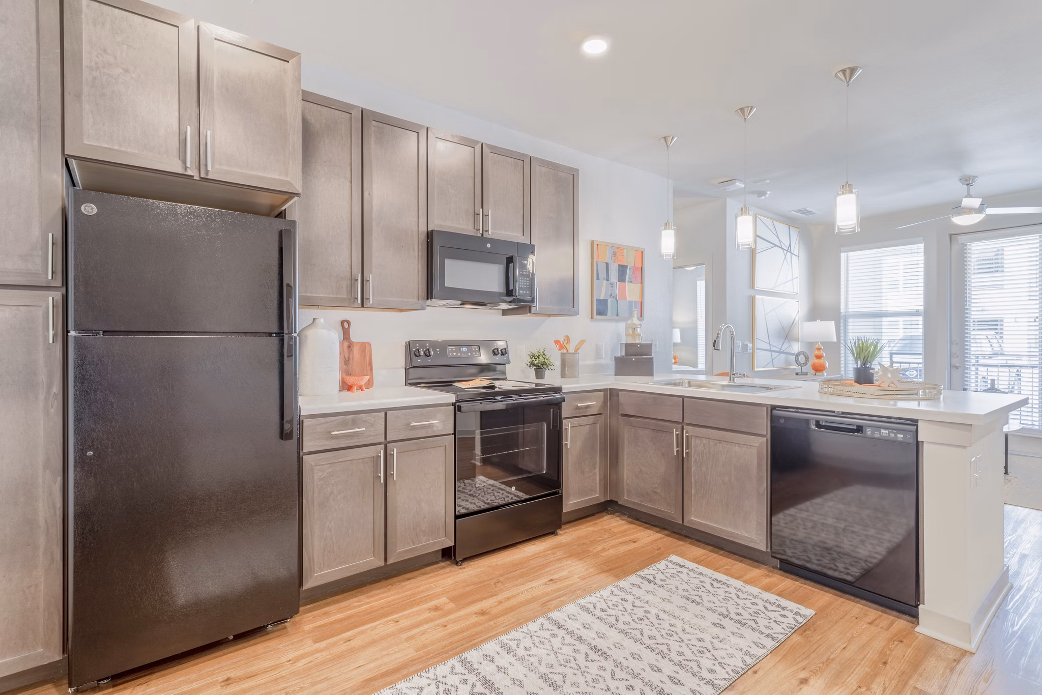 Modern kitchen with stainless steel appliances in Espria Apartments