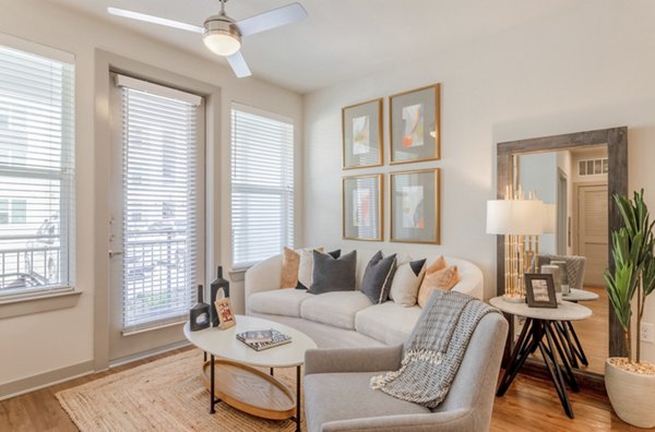 Modern living room with sleek furniture and natural lighting at Espria Apartments by Greystar