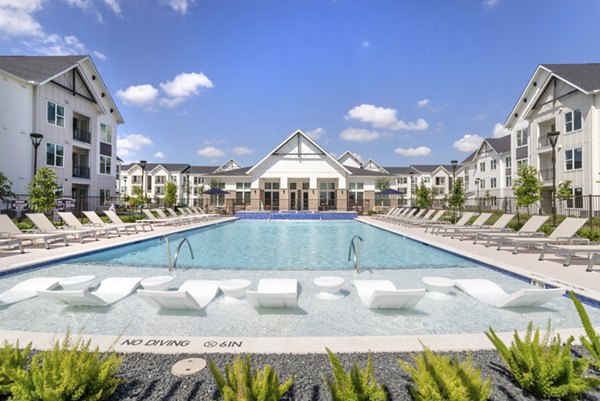 Luxurious pool area with comfortable lounge seating at Espria Apartments