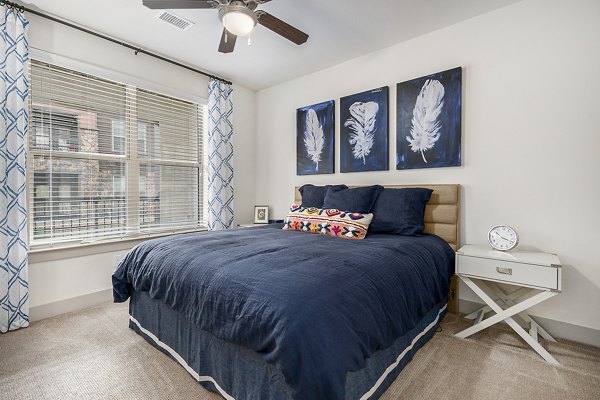Elegant bedroom with modern furnishings at Peak 83 luxury apartments, showcasing stylish design elements for ultimate comfort and relaxation