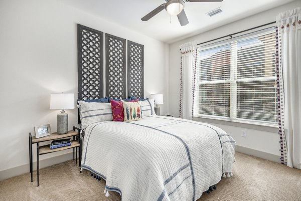 Cozy bedroom with elegant decor at Peak 83 luxury apartments