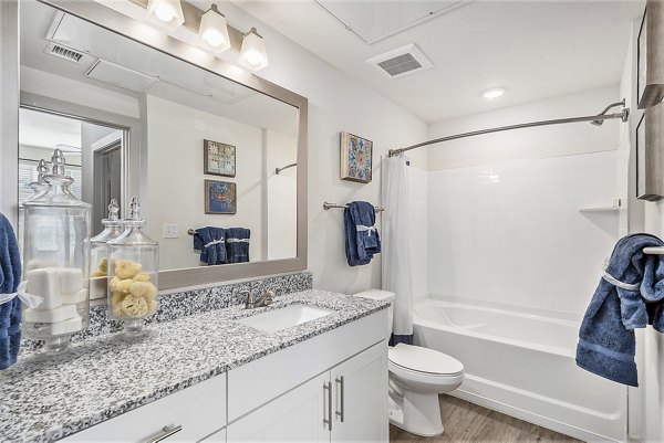 Elegant bathroom featuring modern fixtures and double vanities at Peak 83 luxury apartments