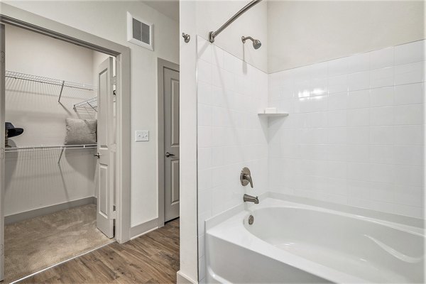 Modern bathroom with sleek fixtures and marble countertops in Peak 83 luxury apartments
