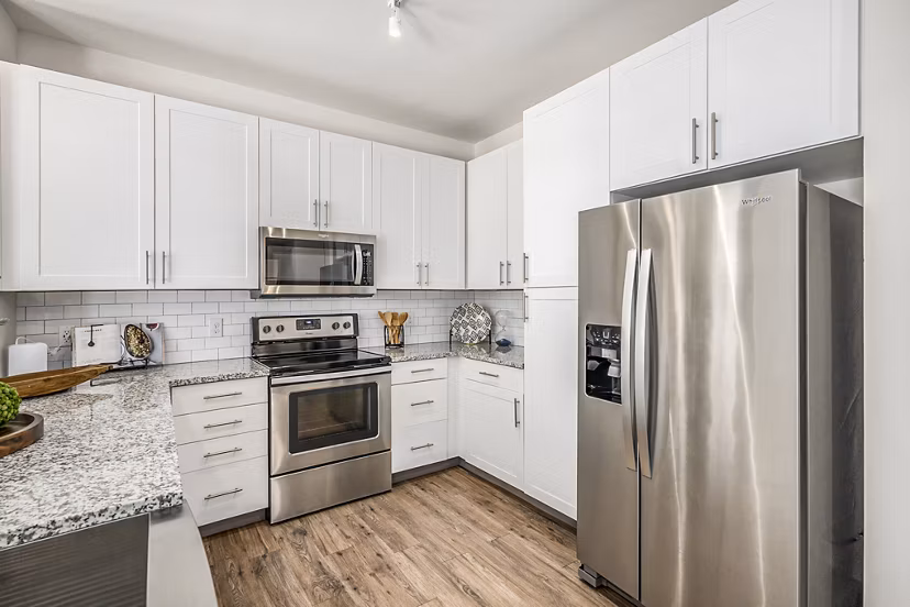 Modern kitchen with sleek countertops and stainless steel appliances at Peak 83 luxury apartments