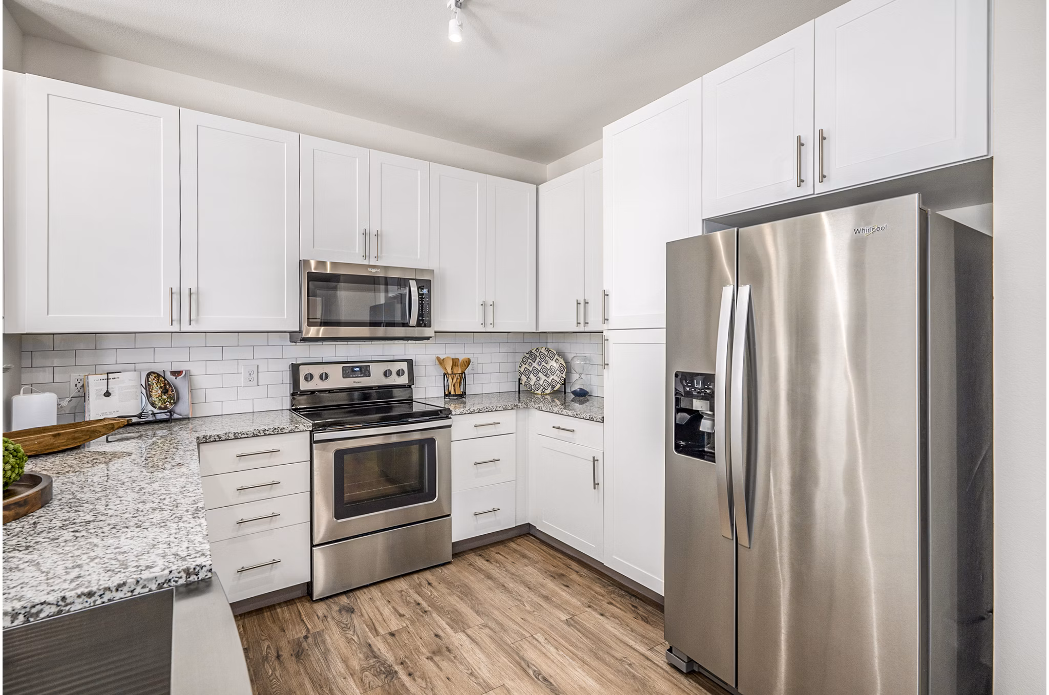 Modern kitchen with sleek countertops and stainless steel appliances at Peak 83 luxury apartments