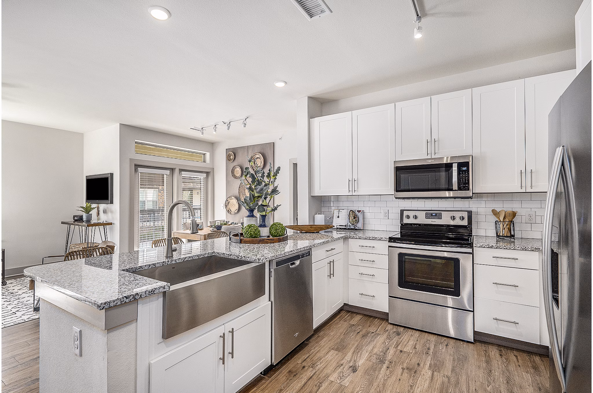 Modern kitchen with stainless steel appliances at Peak 83 luxury apartments