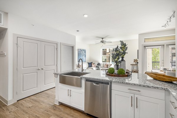 Spacious kitchen with modern appliances and island at Peak 83 apartments, ideal for cooking and entertaining