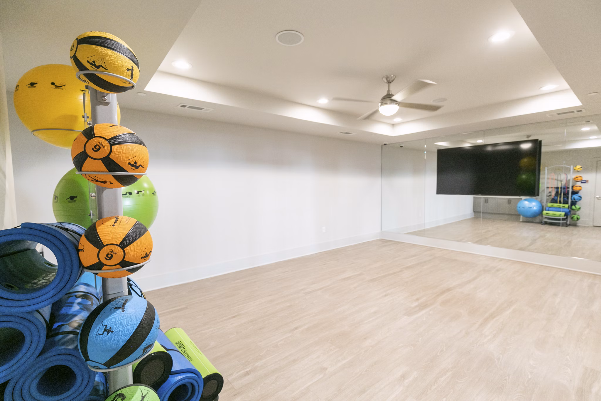 Yoga and spin studio with natural lighting at Annabelle on Main Apartments, offering fitness amenities for active lifestyles
