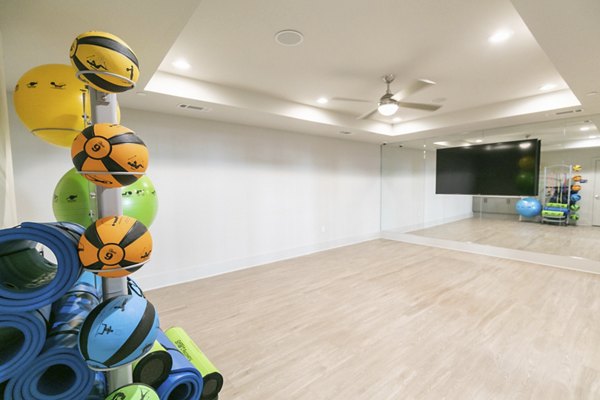 Yoga and spin studio with natural lighting at Annabelle on Main Apartments, offering fitness amenities for active lifestyles