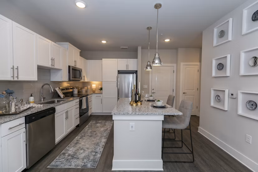 Contemporary kitchen with stainless steel appliances at Annabelle on Main Apartments