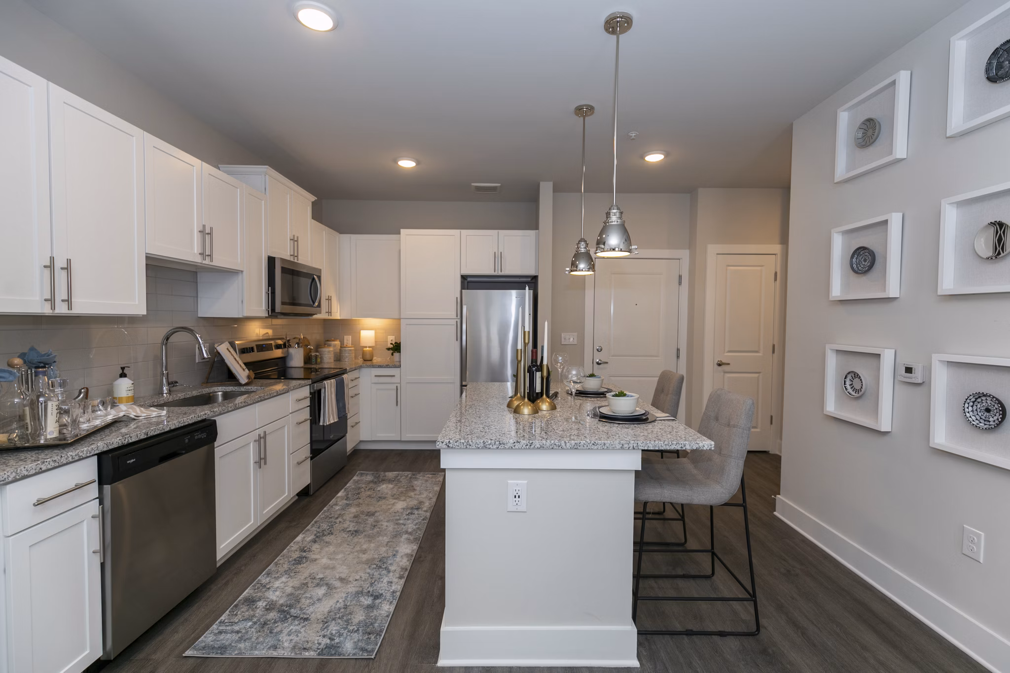 Contemporary kitchen with stainless steel appliances at Annabelle on Main Apartments