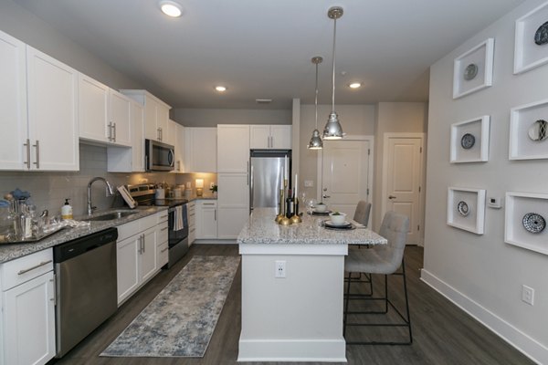 Contemporary kitchen with stainless steel appliances at Annabelle on Main Apartments