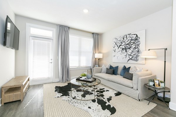 Spacious living room with modern decor in Annabelle on Main Apartments