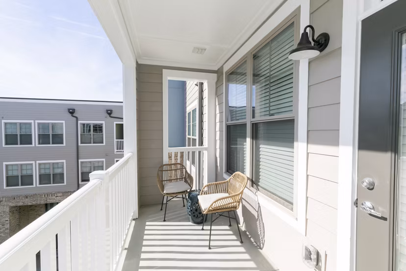 Contemporary outdoor patio at Annabelle on Main Apartments featuring stylish seating and lush greenery