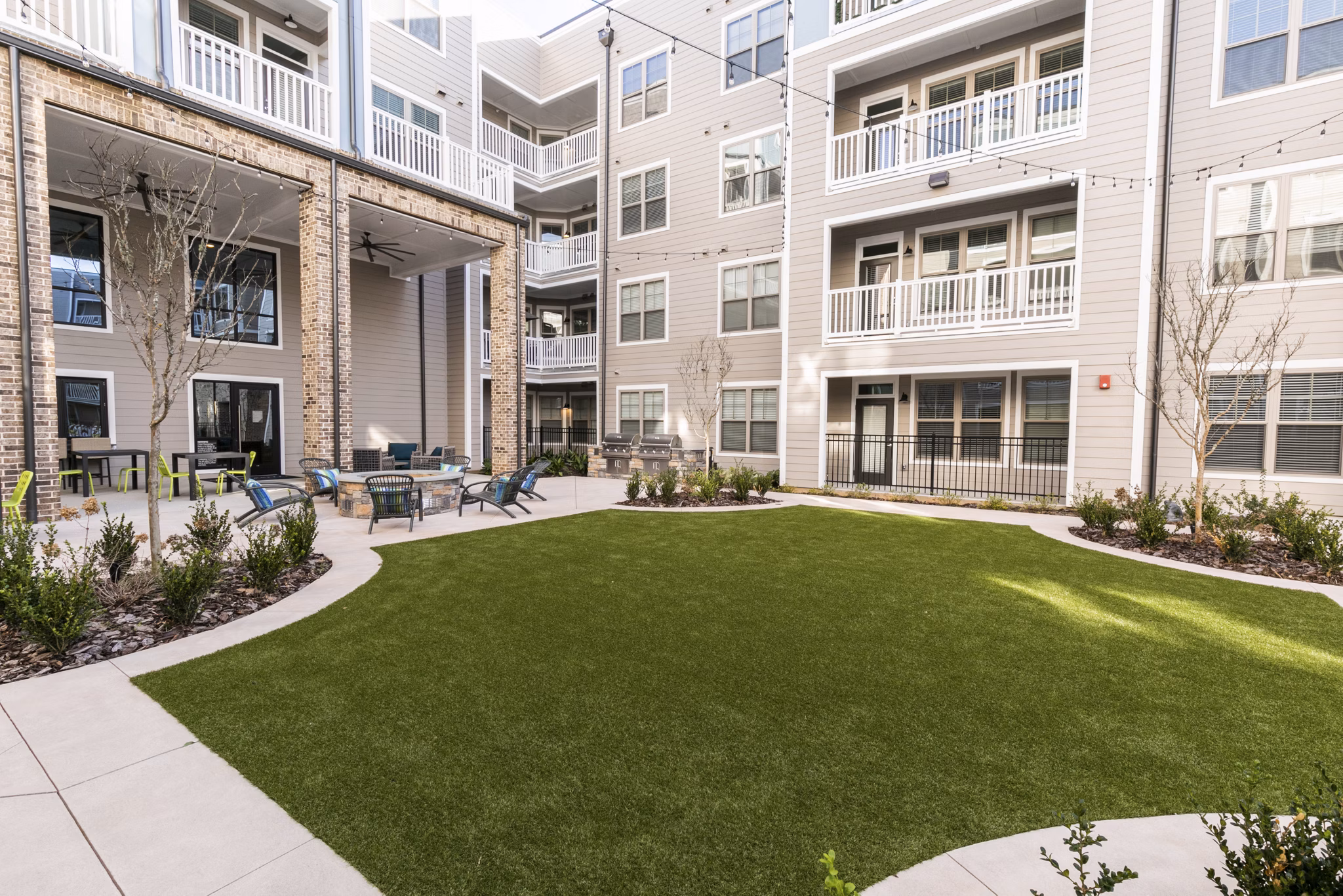 Charming courtyard with lush greenery and seating at Annabelle on Main Apartments, offering luxury living in the heart of the community