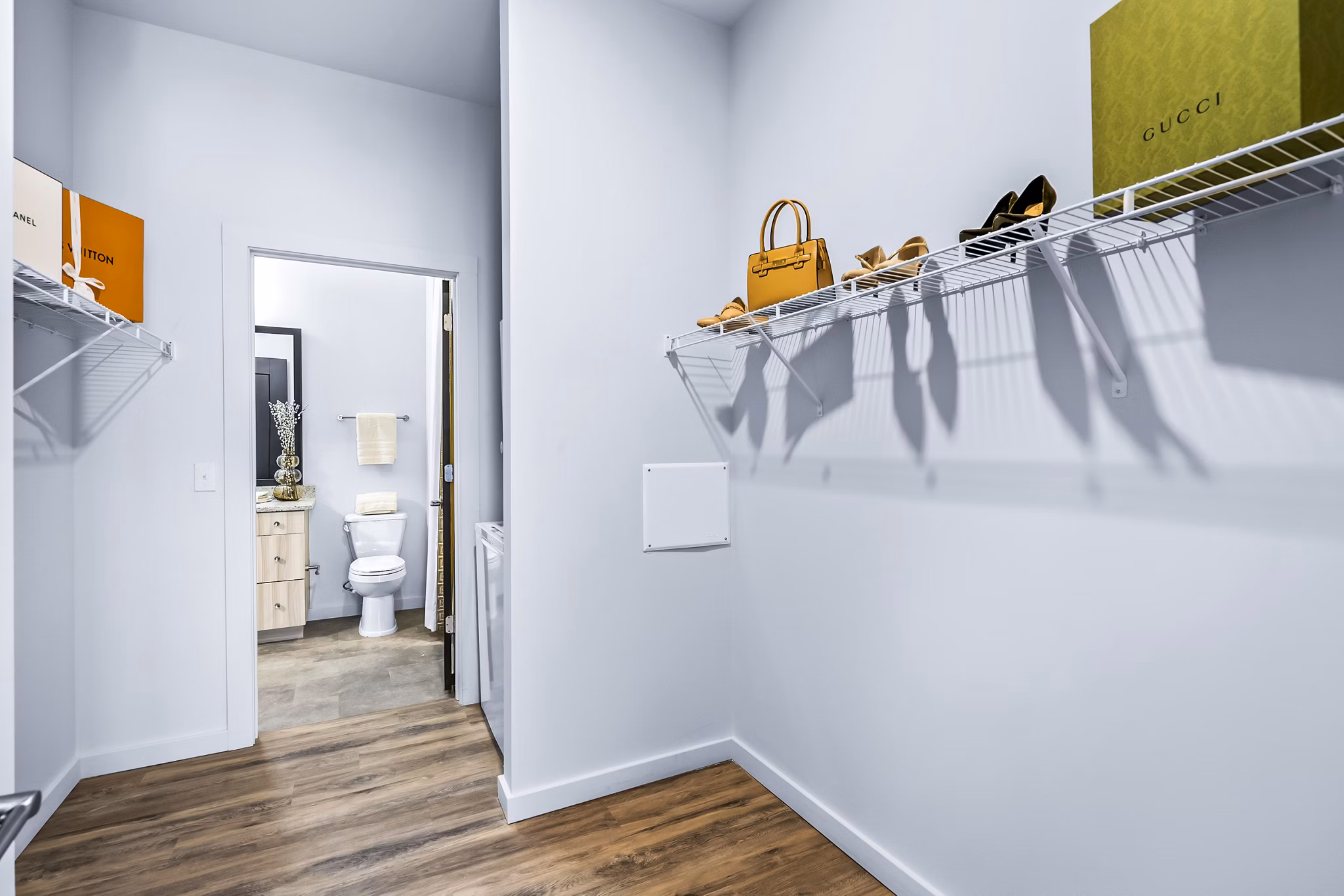 Spacious bedroom closet at Avvio Apartments featuring ample shelving and storage space