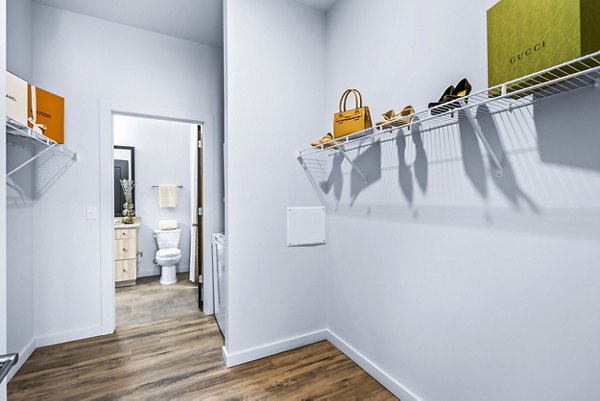 Spacious bedroom closet at Avvio Apartments featuring ample shelving and storage space