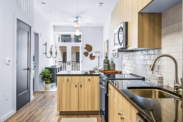 Modern kitchen with stainless steel appliances in Avvio Apartments