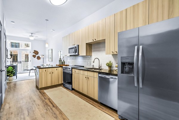 Modern kitchen with sleek cabinetry and stainless steel appliances in Avvio Apartments